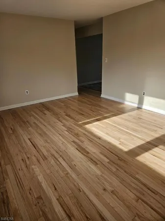 a view of a room with wooden floor