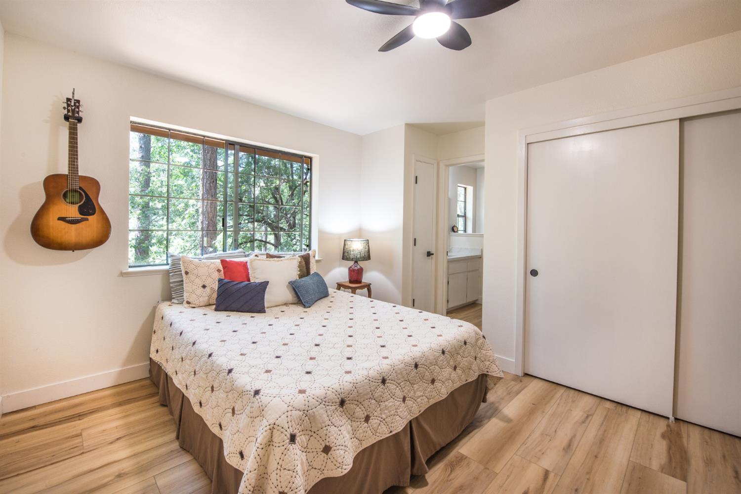 15046 Leiter Way Grass Valley, CA 95949 - Photo 11 of 43 a bedroom with a bed and a chandelier