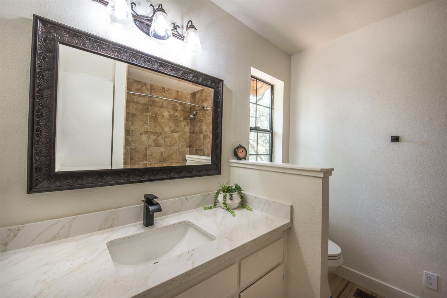 15046 Leiter Way Grass Valley, CA 95949 - Photo 12 of 43 a bathroom with a sink vanity and a mirror