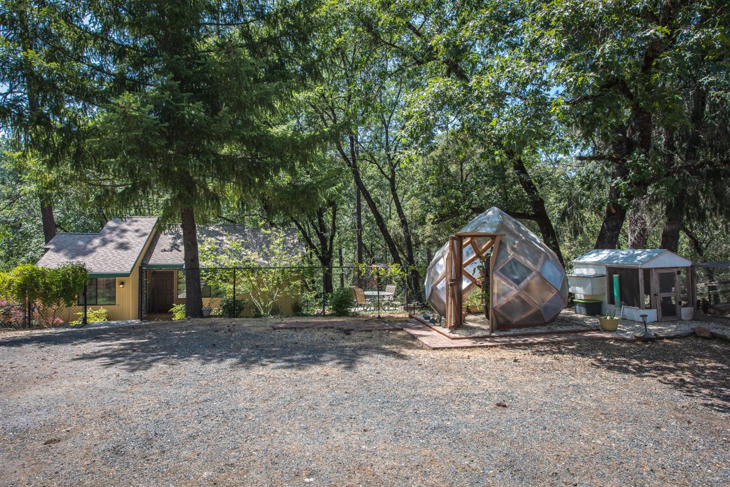 15046 Leiter Way Grass Valley, CA 95949 - Photo 24 of 43 a backyard of a house with barbeque oven table and chairs