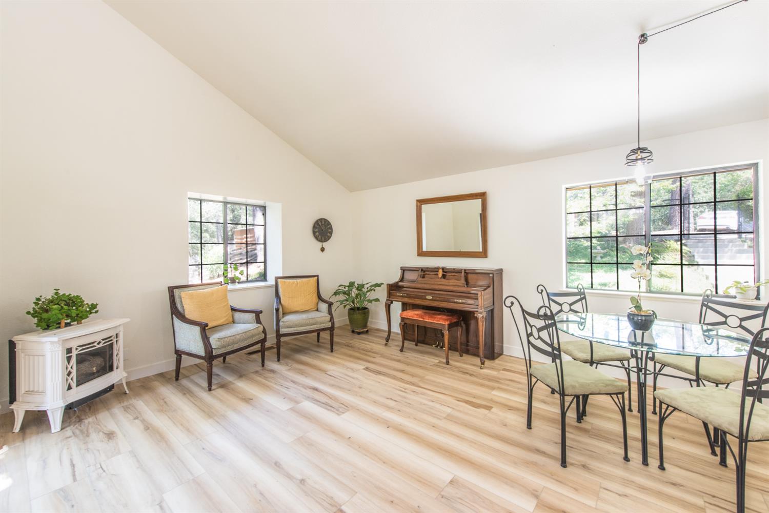 15046 Leiter Way Grass Valley, CA 95949 - Photo 6 of 43 a living room with furniture a fireplace and a wooden floor