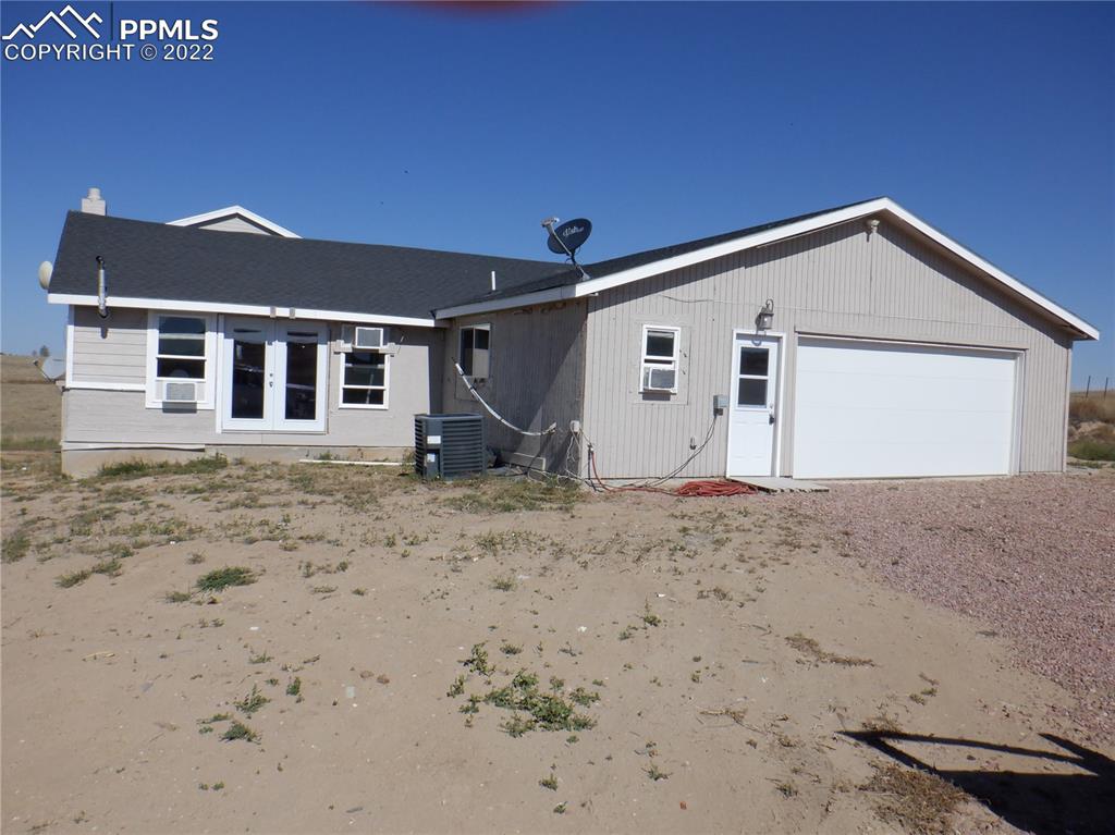 995 Choate Lane Yoder, CO 80864 - Photo 2 of 48 a view of a house with a yard