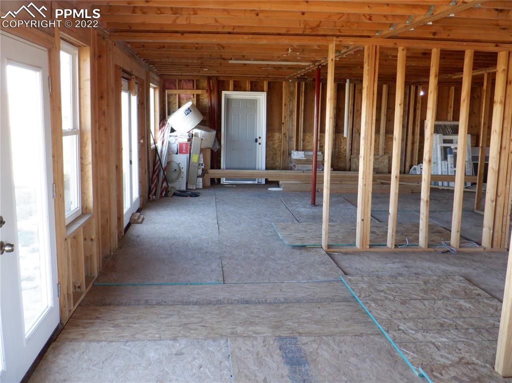 995 Choate Lane Yoder, CO 80864 - Photo 24 of 48 a view of a porch with wooden floor and stairs