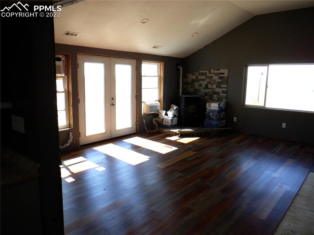 995 Choate Lane Yoder, CO 80864 - Photo 33 of 48 a living room with hardwood floor and large window
