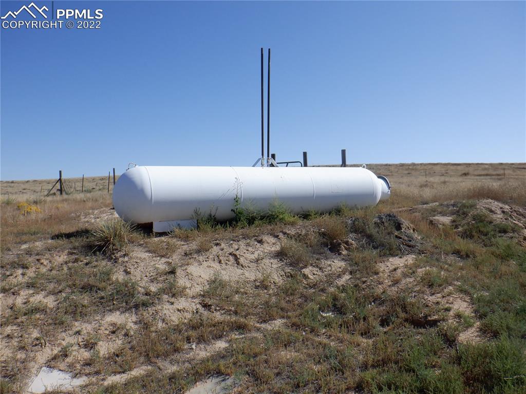 995 Choate Lane Yoder, CO 80864 - Photo 39 of 48 a bed sitting in a spacious bedroom next to a large building