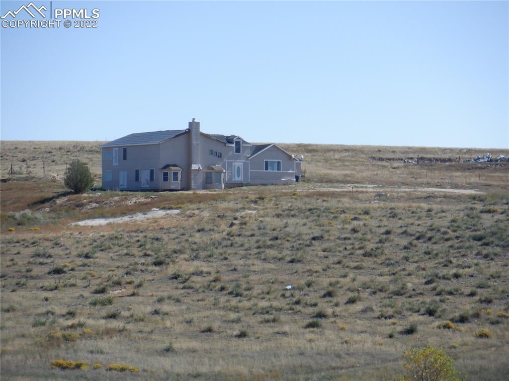 995 Choate Lane Yoder, CO 80864 - Photo 41 of 48 a view of a large building with a yard