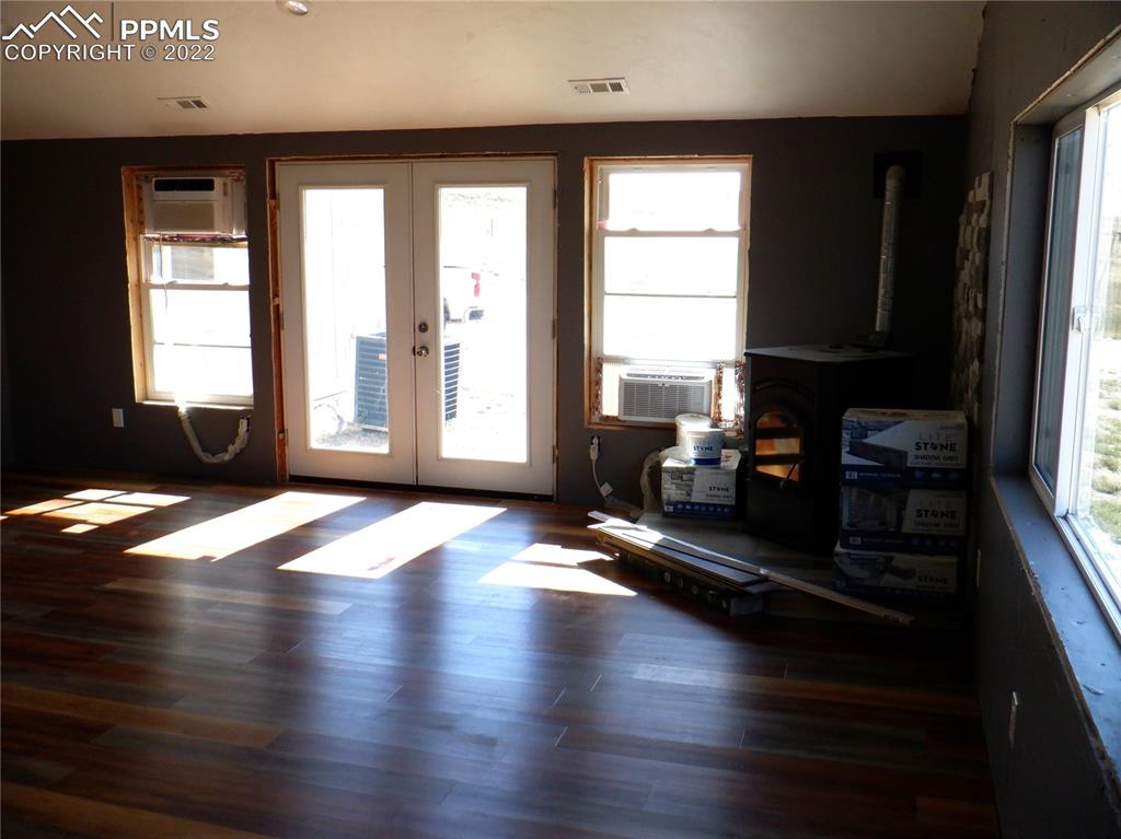 995 Choate Lane Yoder, CO 80864 - Photo 43 of 48 a view of a livingroom with wooden floor and a window