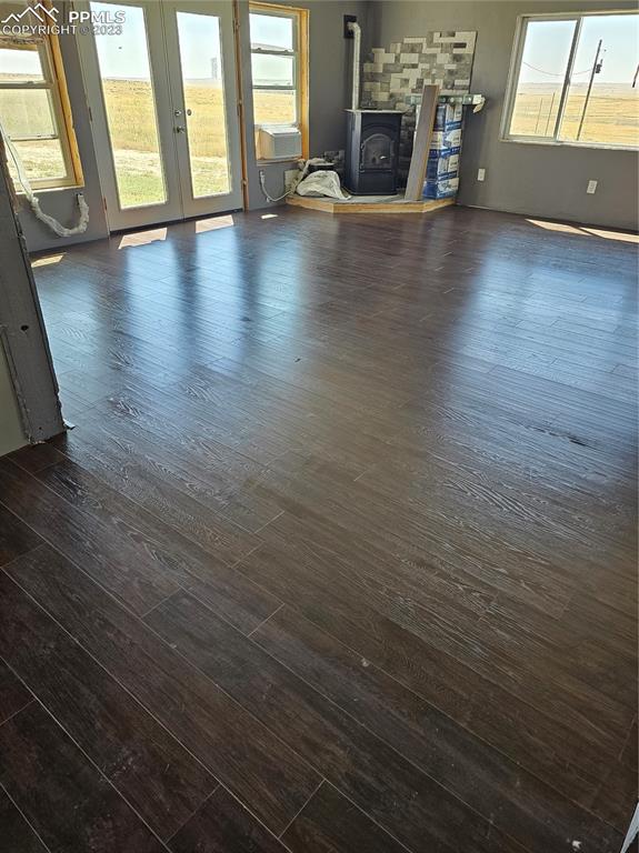 995 Choate Lane Yoder, CO 80864 - Photo 47 of 48 an empty room with wooden floor and a fireplace