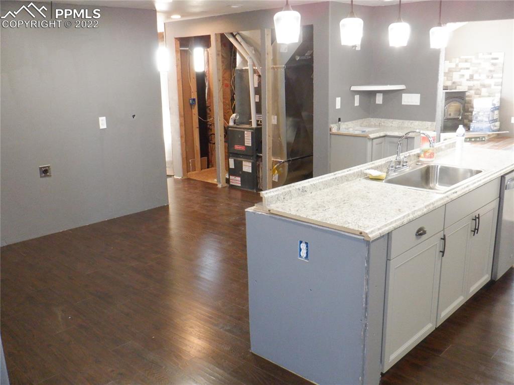 995 Choate Lane Yoder, CO 80864 - Photo 10 of 48 a kitchen with a sink cabinets and wooden floor