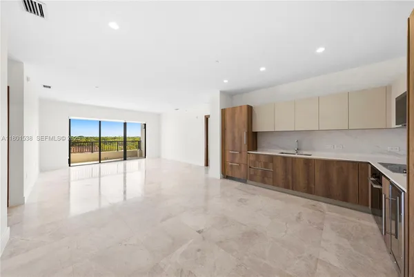 a view of a kitchen with a sink and cabinets