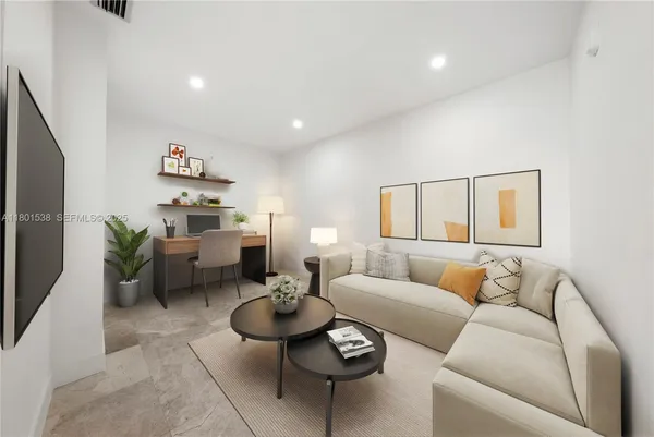 a living room with furniture and wooden floor