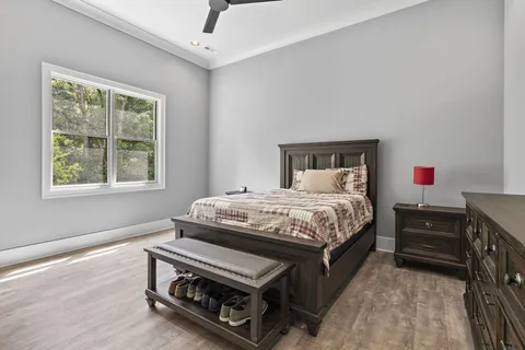 a bedroom with a bed cabinets and window