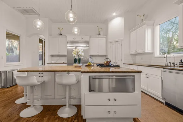 a kitchen with a sink stove and cabinets
