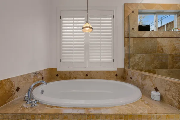 a bathroom with a bathtub and shower