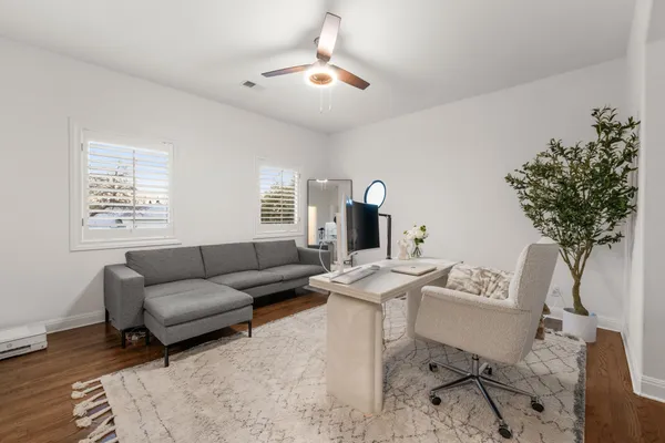 a living room with furniture a table and a potted plant