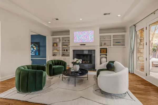 a living room with furniture a fireplace and a flat screen tv