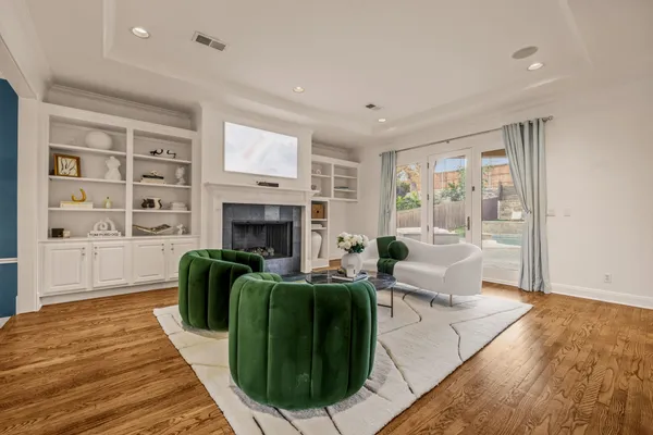 a living room with furniture a fireplace and a wooden floor