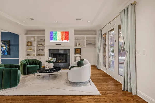 a living room with furniture wooden floor and a fireplace