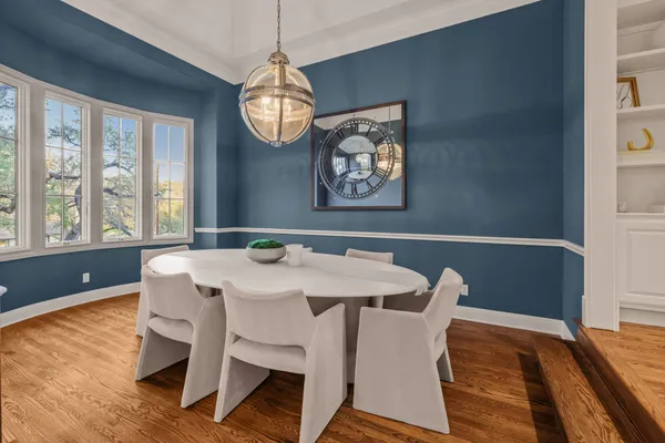a view of a dining room with furniture wooden floor and chandelier