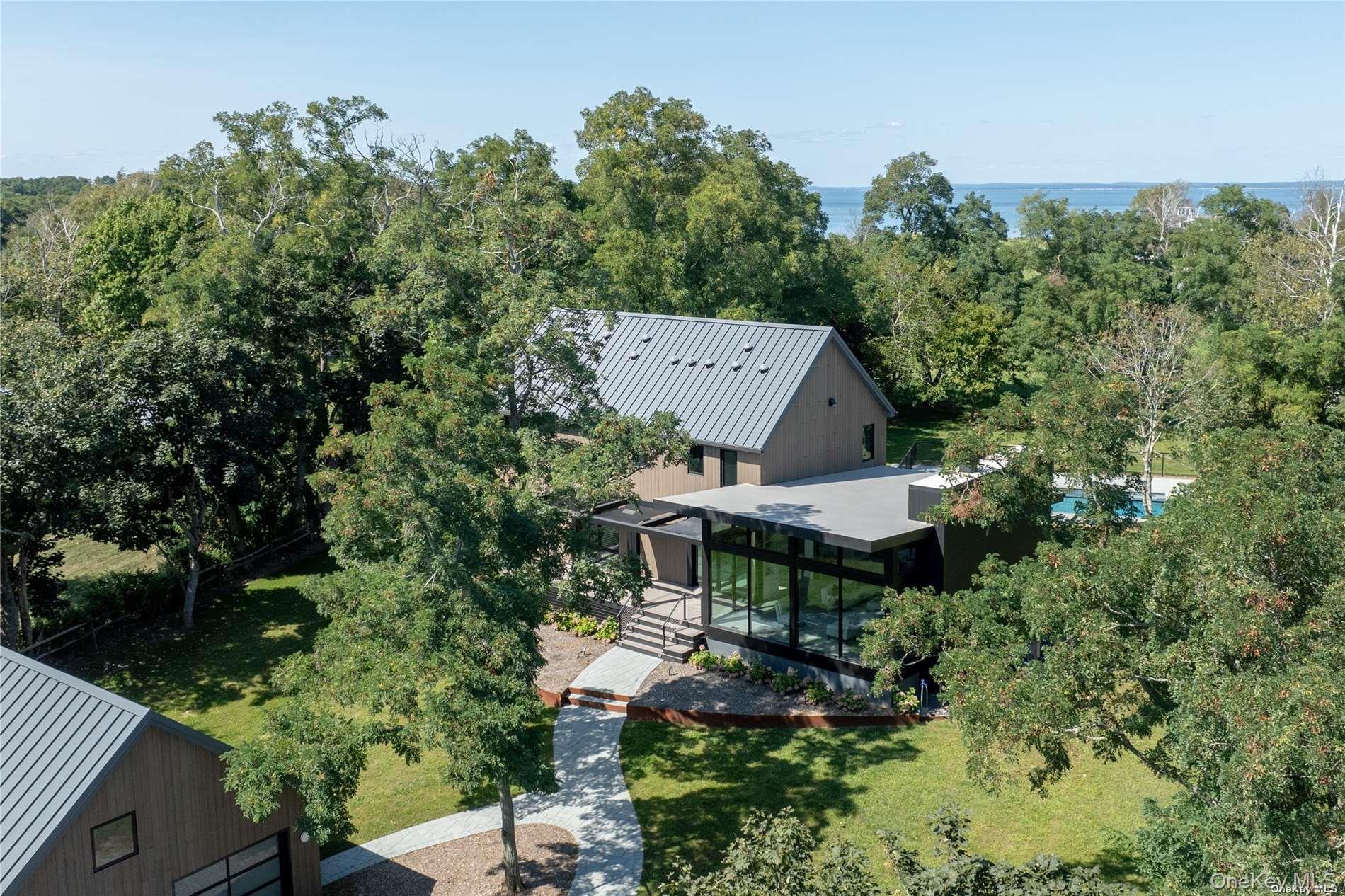 290 Windward Road Orient, NY 11957 - Photo 7 of 31 an aerial view of a house with a yard table and chairs