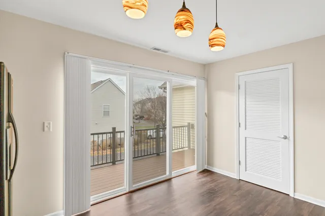 an empty room with wooden floor and window