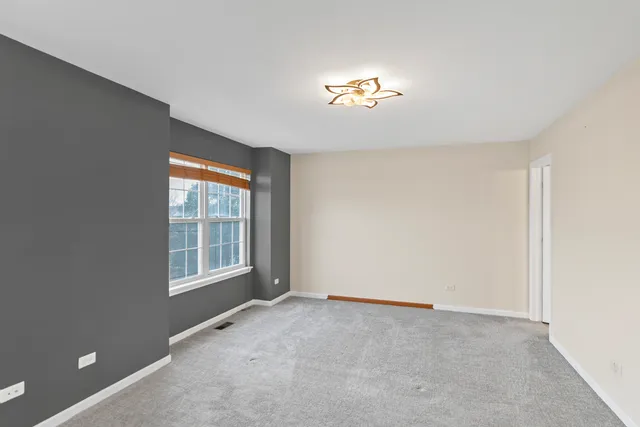 an empty room with a empty space and a window