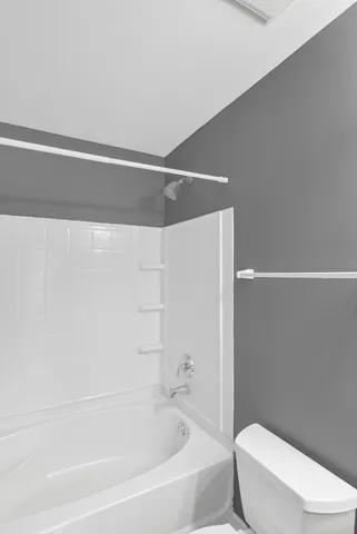 a bathroom with a toilet and a bathtub