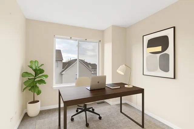 a workspace with furniture and a potted plant
