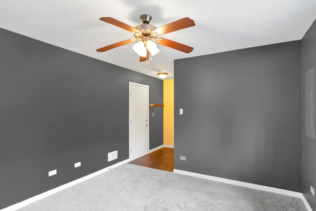 a view of a big yard in front of a brick building