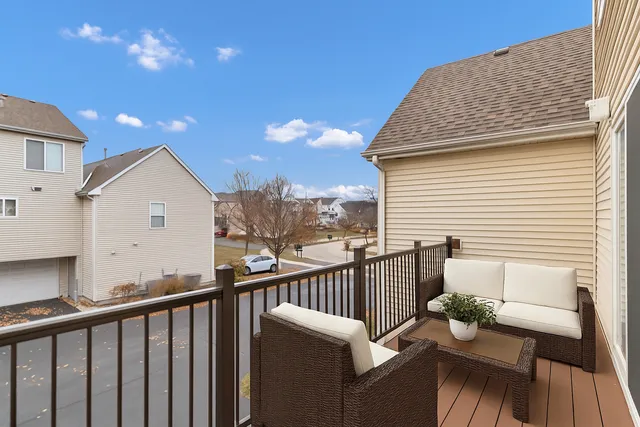 a view of a balcony with wooden floor and fence