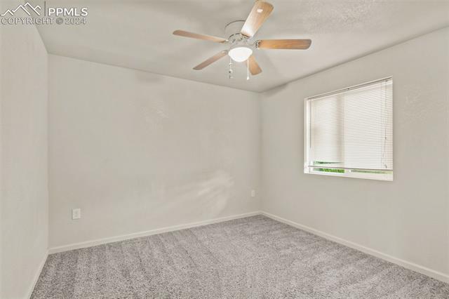 6010 Oak Street Rye, CO 81069 - Photo 8 of 29 Empty room featuring ceiling fan and light colored carpet