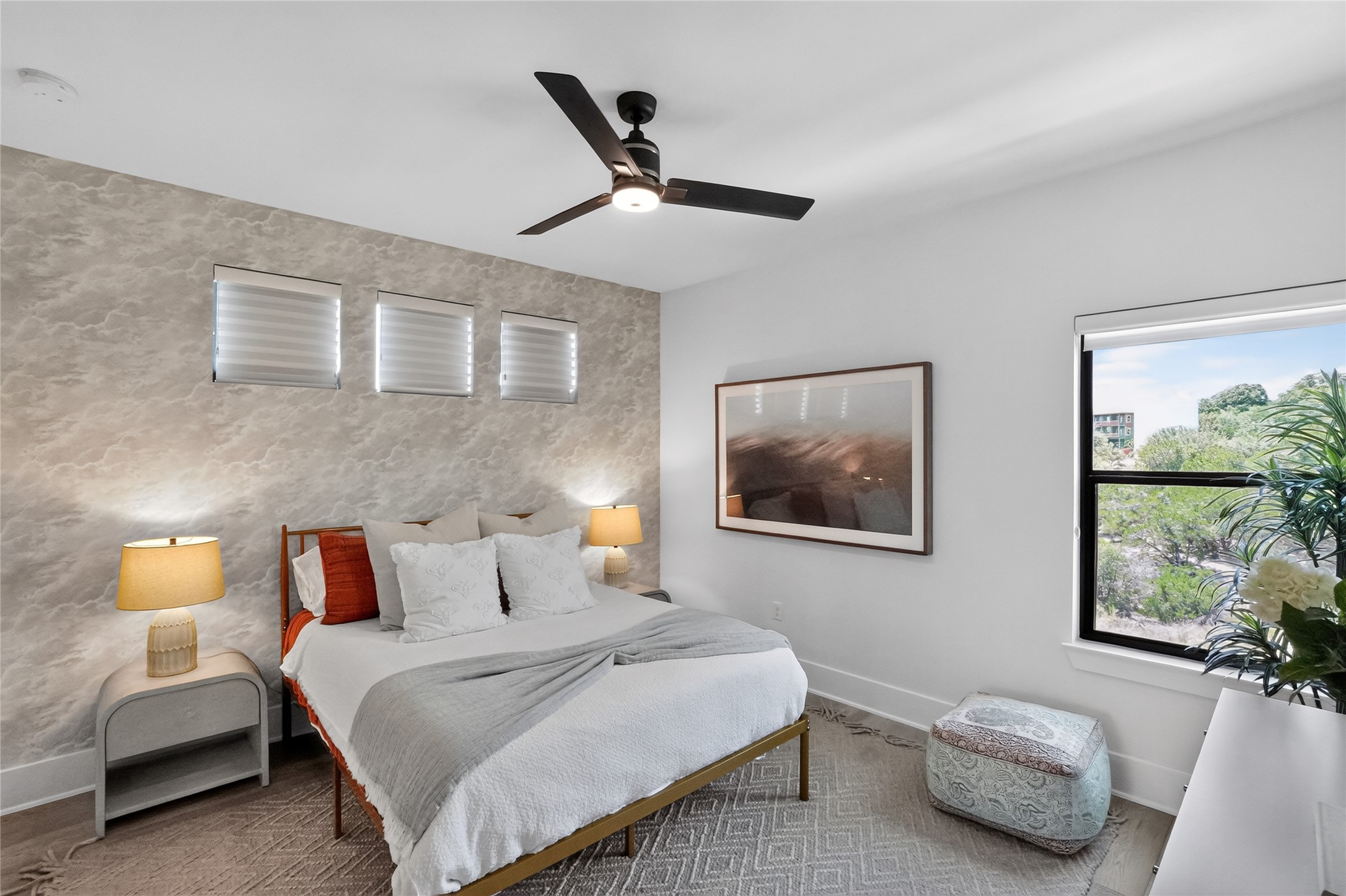 14916 Copper Ridge Lane Austin, TX 78734 - Photo 24 of 35 A tranquil sleeping space featuring a stylish ceiling fan and scenic outdoor views.