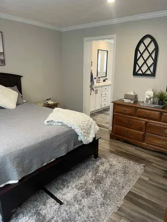 a bedroom with a bed and a dresser