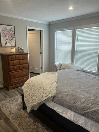 a bedroom with a bed and a window