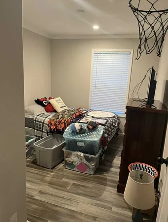 a bedroom with furniture and a wooden floor