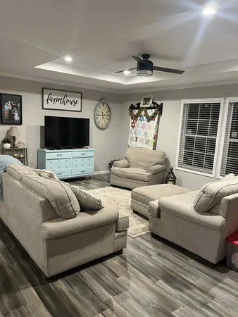 a living room with furniture and a large window
