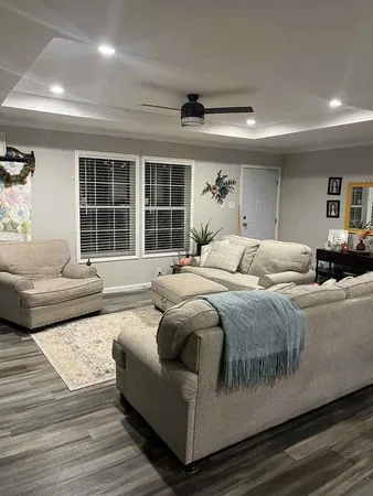 a bedroom with a large bed couch and a window