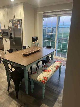 a view of a dining room with furniture and a window