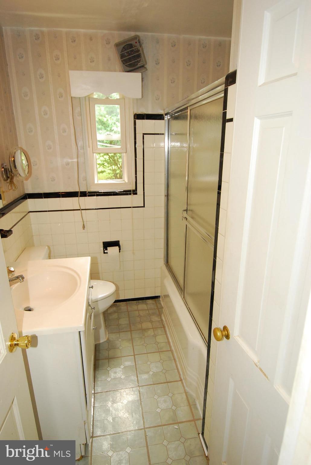 26609 Ridge Road Damascus, MD 20872 - Photo 7 of 17 a bathroom with a toilet and a shower