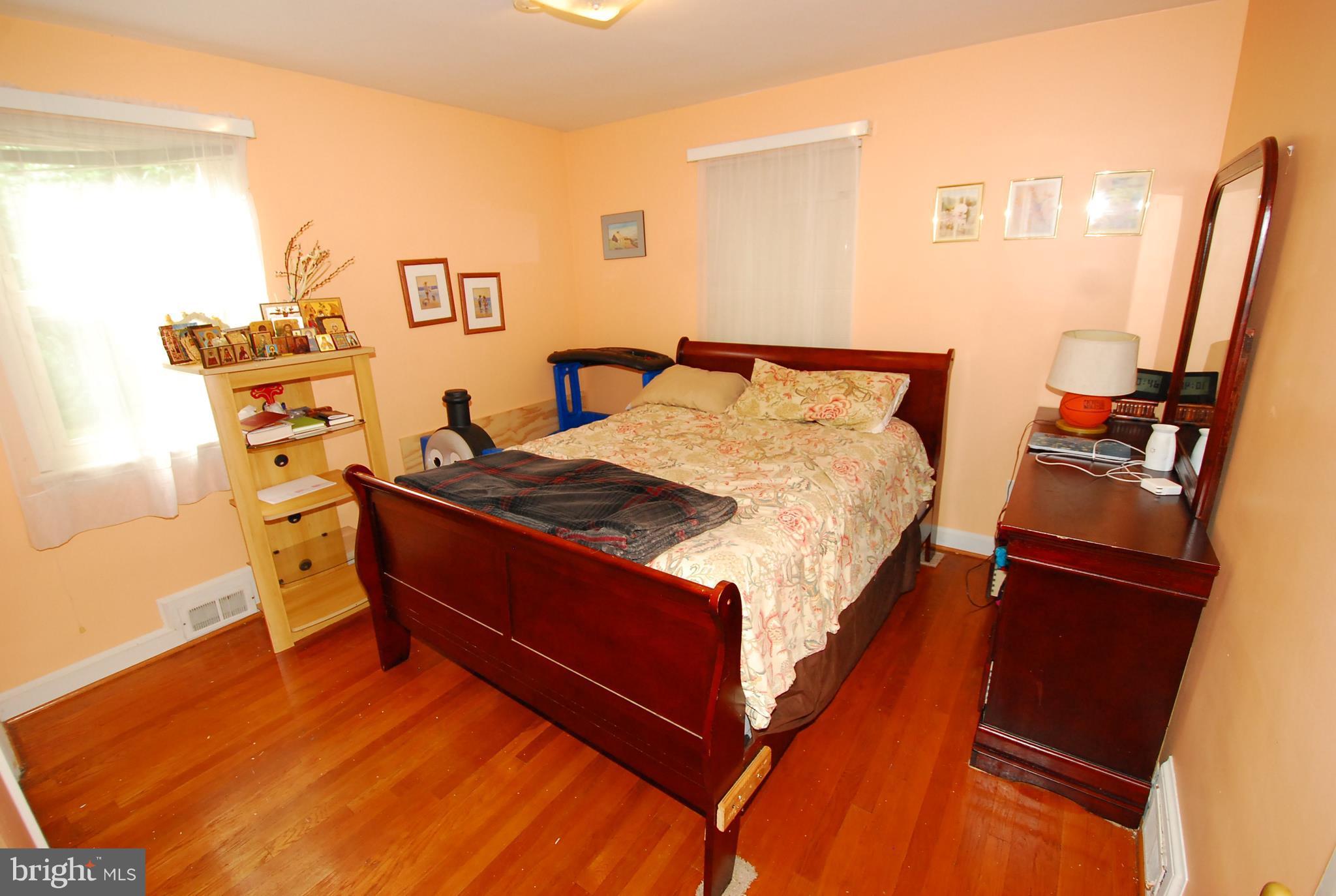 26609 Ridge Road Damascus, MD 20872 - Photo 8 of 17 a bed room with a bed and a desk