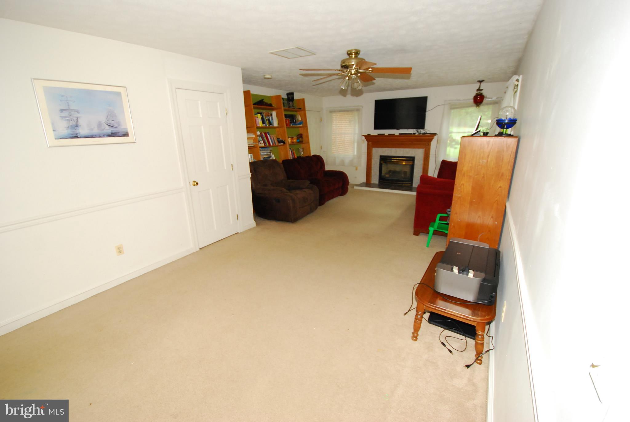 26609 Ridge Road Damascus, MD 20872 - Photo 9 of 17 a living room with furniture and a flat screen tv
