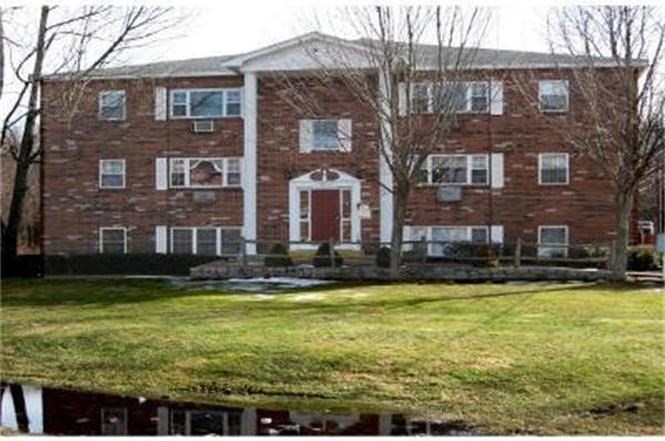 43 Berlin Street, Unit 411 Clinton, MA 01510 - Photo 1 of 14 a view of a building with a swimming pool