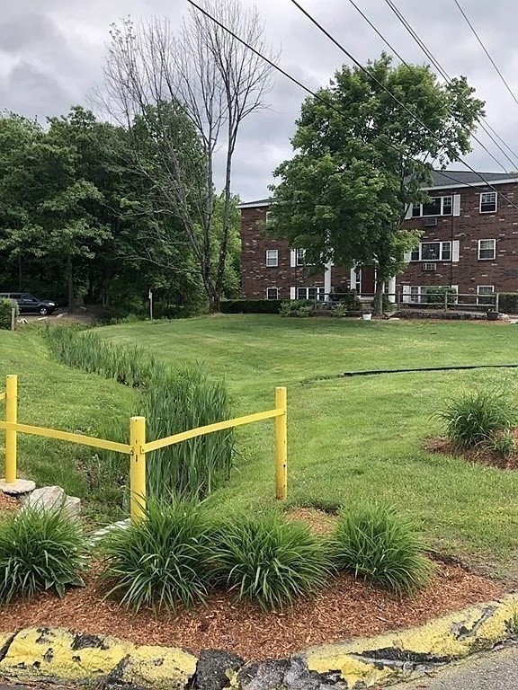 43 Berlin Street, Unit 411 Clinton, MA 01510 - Photo 13 of 14 a view of a garden with a house in the background