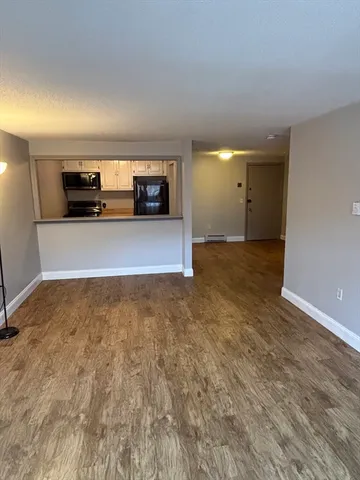 a kitchen with a refrigerator and a stove top oven