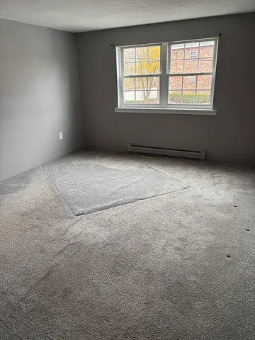 a view of entryway with window and wooden floor