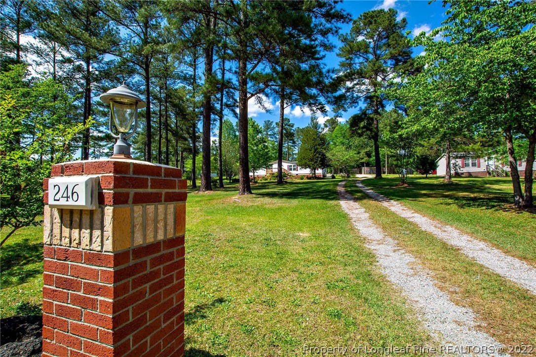246 Loop Road Raeford, NC 28376 - Photo 1 of 42 a front view of a building with garden