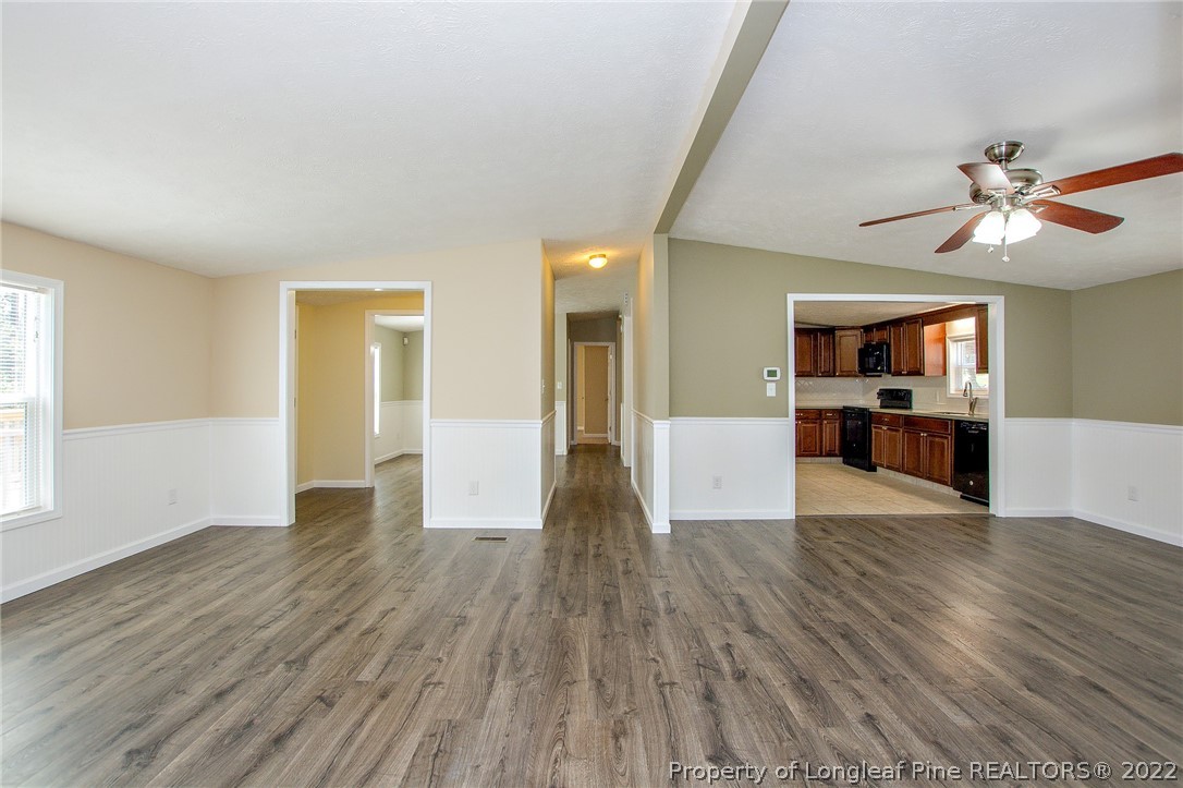 246 Loop Road Raeford, NC 28376 - Photo 13 of 42 a view of a big room with wooden floor and a kitchen