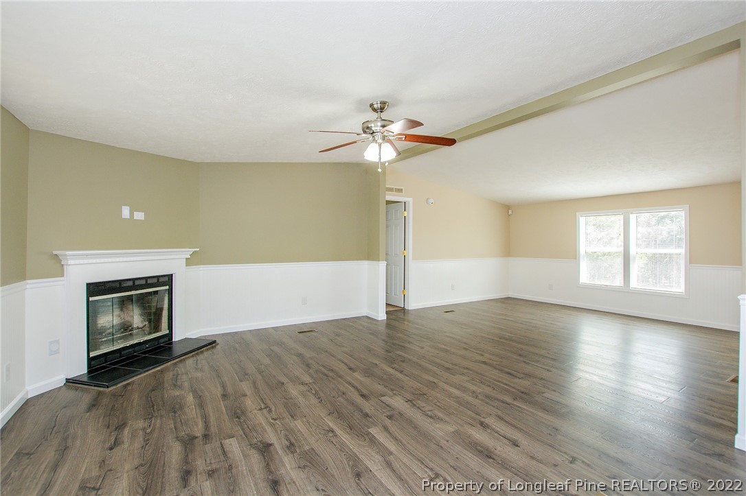 246 Loop Road Raeford, NC 28376 - Photo 14 of 42 a view of empty room with wooden floor and fireplace