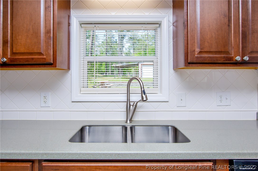 246 Loop Road Raeford, NC 28376 - Photo 17 of 42 a kitchen with a sink and cabinets