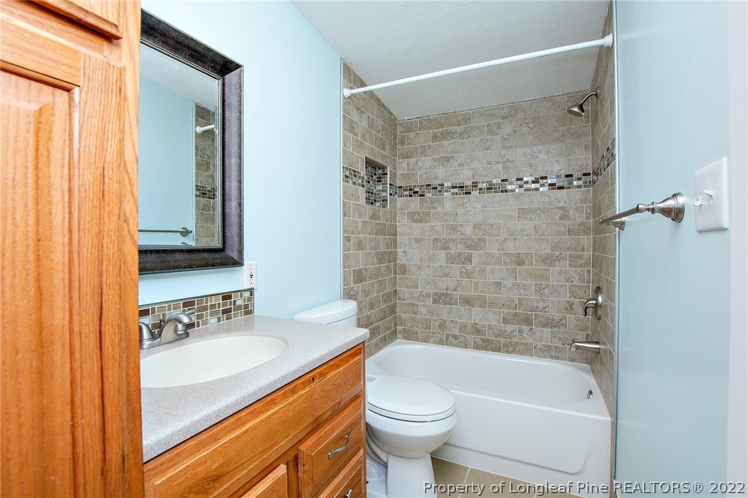 246 Loop Road Raeford, NC 28376 - Photo 20 of 42 a bathroom with a sink a toilet and shower